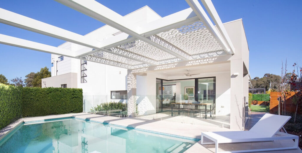 If space is no issue adding a pergola to your pool area will give it that WOW factor